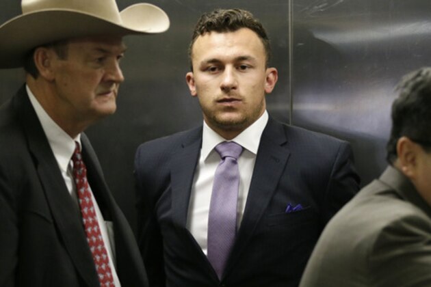 Former NFL quarterback Johnny Manziel, center, takes an elevator with his lawyer Jim Darnell, left, after a court hearing in Dallas, Tuesday, Feb. 28, 2017. A Dallas County judge ordered Manziel to be at the hearing to address concerned about reports that he has violated terms of a plea agreement for a domestic violence case. (AP Photo/LM Otero)