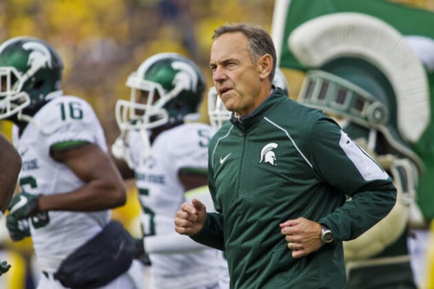 FILE - In this Oct. 17, 2015, file photo, Michigan State head coach Mark Dantonio, runs on to the Michigan Stadium field with his team before an NCAA college football game against Michigan in Ann Arbor, Mich. Dantonio believes Michigan State will upset No. 2 Michigan and he's not afraid to say it. In fact, Dantonio said in an interview with The Associated Press the Spartans' chances of winning Saturday are better than they were with 10 seconds left in last year's game at Michigan Stadium. (AP Photo/Tony Ding, File0