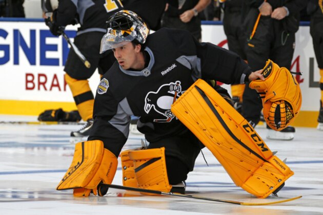 Pittsburgh Penguins goalie Marc-Andre Fleury picks up his stick during hockey practice at Heinz Field, Friday, Feb. 24, 2017 in Pittsburgh. The Penguins are preparing to face the Philadelphia Flyers in an outdoor hockey game Saturday, Feb. 25, 2017. (AP Photo/Gene J. Puskar)
