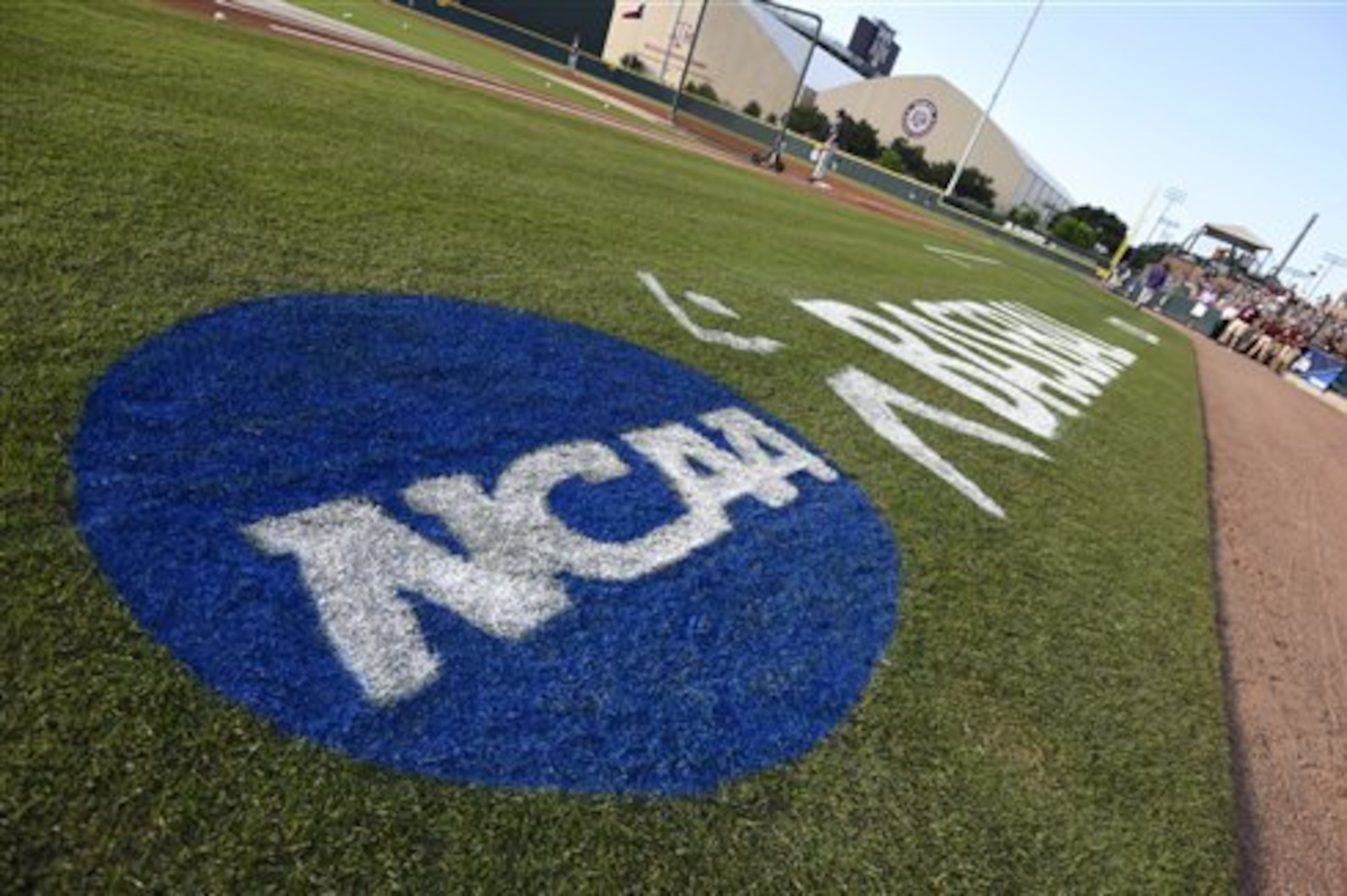 The NCAA logo is painted alongside the visitor dugout at Olsen Field before the start of a NCAA college baseball super regional tournament game between TCU and Texas A&M, Friday, June 10, 2016, in College Station, Texas. TCU won game one of the series 8-2. (AP Photo/Sam Craft)