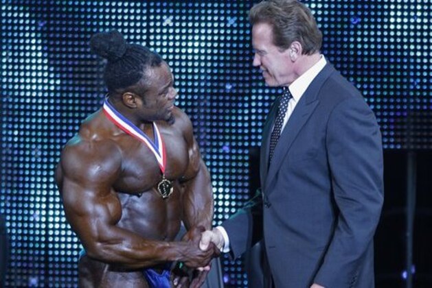 California Gov. Arnold Schwarzenegger, right, congratulates Kai Greene on his victory in the 2009 Arnold Classic body building competition during the Arnold Sports Festival Saturday, March 7, 2009, in Columbus, Ohio. (AP Photo/Jay LaPrete)