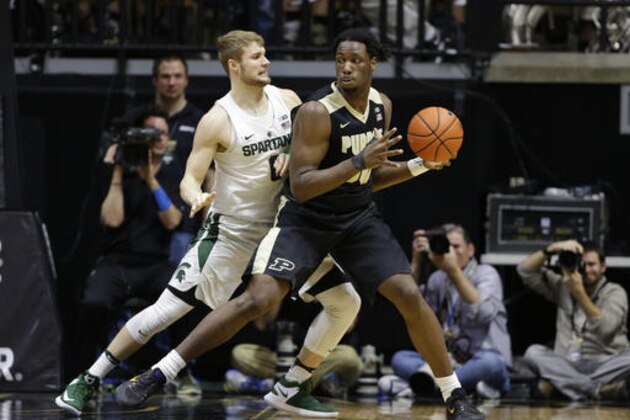 Michigan State guard Kyle Ahrens (0) defends Purdue forward Caleb Swanigan (50) in the first half of an NCAA college basketball game in West Lafayette, Ind., Saturday, Feb. 18, 2017. (AP Photo/Michael Conroy)