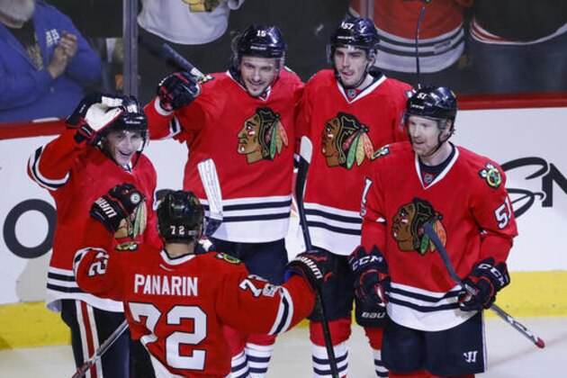 Chicago Blackhawks center Artem Anisimov (15) celebrates with right wing Patrick Kane (88), left wing Artemi Panarin (72), defenseman Trevor van Riemsdyk (57) and defenseman Brian Campbell (51) after scoring against the St. Louis Blues during the third period of an NHL hockey game Sunday, Feb. 26, 2017, in Chicago. The Blackhawks won 4-2. (AP Photo/Kamil Krzaczynski)