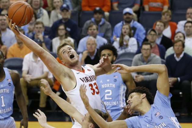Virginia center Jack Salt (33) reaches for a rebound over North Carolina forward Justin Jackson (44) during the first half of an NCAA college basketball game in Charlottesville, Va., Monday, Feb. 27, 2017. (AP Photo/Steve Helber)