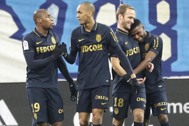 Monaco's Djibril Sidibe, left, Fabio Henrique Tavares Fabinho, second left, France's Valere Germain, second right, and Thomas Lemar celebrate after Lemar scored against Marseille, during the League One soccer match between Marseille and Monaco, at the Velodrome Stadium, in Marseille, southern France, Sunday, Jan.15, 2017. (AP Photo/Claude Paris)