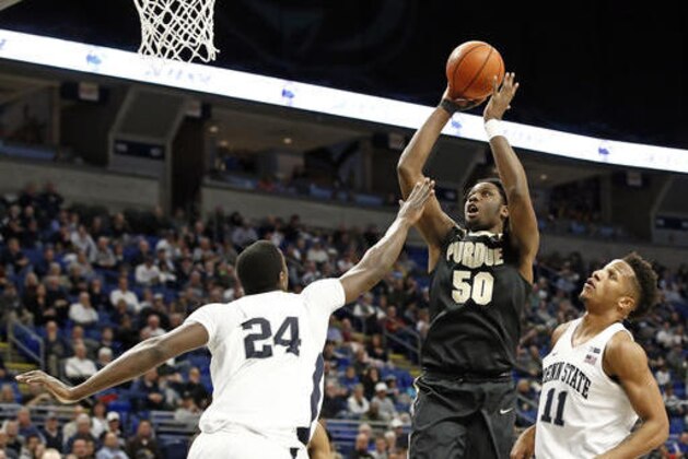 Purdue's Caleb Swanigan (50) shoots between Penn State's Mike Watkins (24) and Lamar Stevens during the second half of an NCAA college basketball game in State College, Pa., Tuesday, Feb. 21, 2017. Purdue won 74-70 in overtime. (AP Photo/Chris Knight)