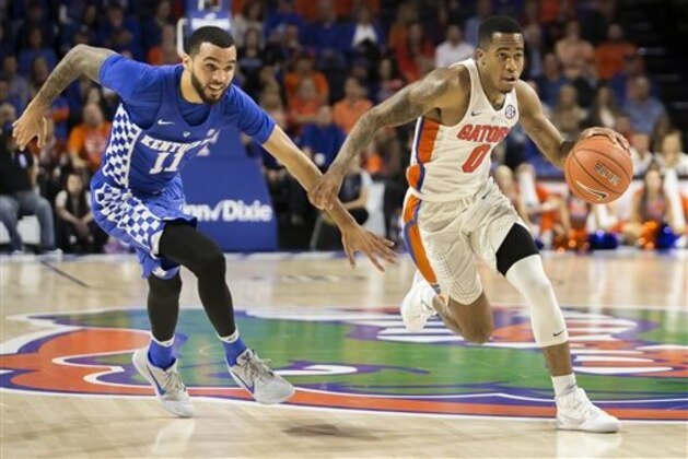 Florida guard Kasey Hill (0) dribbles past Kentucky guard Mychal Mulder (11) on a fast break during the second half of an NCAA college basketball game in Gainesville, Fla., Saturday, Feb. 4, 2017.   Florida won 88-66. (AP Photo/Ron Irby)