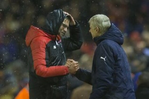 Liverpool's manager Juergen Klopp, left, shakes hands with Arsenal's manager Arsene Wenger after their team's 3-3 draw in the English Premier League soccer match between Liverpool and Arsenal at Anfield Stadium, Liverpool, England, Wednesday, Jan. 13, 2016. (AP Photo/Jon Super)