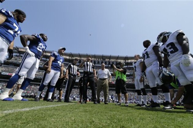 Indianapolis Colts and Philadelphia Eagles players watch the coin toss before a preseason NFL football game, Sunday, Aug. 16, 2015, in Philadelphia. (AP Photo/Matt Rourke)