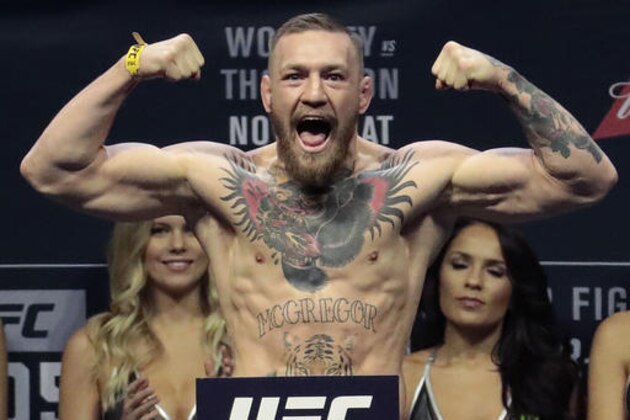 FILE - In this Friday, Nov. 11, 2016, file photo, Conor McGregor stands on a scale during the weigh-in event for his fight against Eddie Alvarez in UFC 205 mixed martial arts at Madison Square Garden in New York. (AP Photo/Julio Cortez, File)
