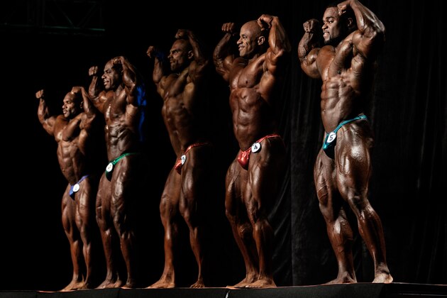 Professional bodybuilders pose on stage during a competition at the Arnold Classic Brazil 2015 in Rio de Janeiro, Brazil, on May 30, 2015. The 3rd annual multi-disciplinary sports competition is named after Austrian-American actor, politician and former bodybuilder Arnold Schwarzenegger.   AFP PHOTO / YASUYOSHI CHIBA        (Photo credit should read YASUYOSHI CHIBA/AFP/Getty Images)