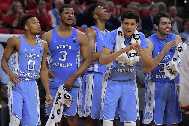 RALEIGH, NC - FEBRUARY 15: Nate Britt #0, Kennedy Meeks #3, Tony Bradley #5, Justin Jackson #44 and Luke Maye #32 of the North Carolina Tar Heels celebrate near the end of a game against the North Carolina State Wolfpack at PNC Arena on February 15, 2017 in Raleigh, North Carolina. UNC won 97-73. (Photo by Lance King/Getty Images)