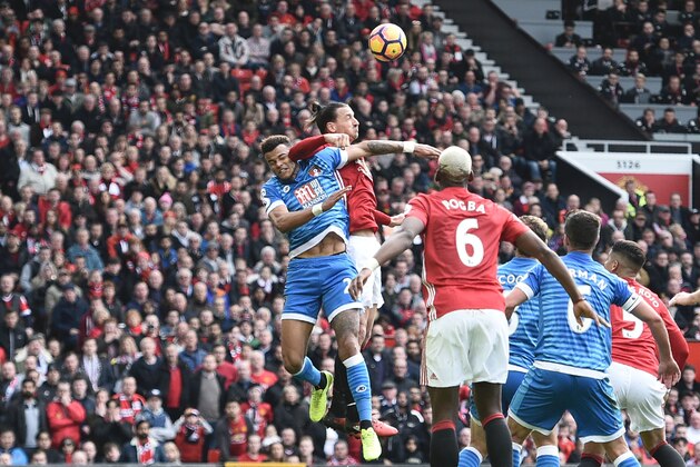 TOPSHOT - Manchester United's Swedish striker Zlatan Ibrahimovic (2L) clashes in the air with Bournemouth's English defender Tyrone Mings (L) during the English Premier League football match between Manchester United and Bournemouth at Old Trafford in Manchester, north west England, on March 4, 2017. / AFP PHOTO / Oli SCARFF / RESTRICTED TO EDITORIAL USE. No use with unauthorized audio, video, data, fixture lists, club/league logos or 'live' services. Online in-match use limited to 75 images, no video emulation. No use in betting, games or single club/league/player publications.  /         (Photo credit should read OLI SCARFF/AFP/Getty Images)