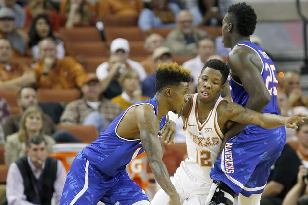 AUSTIN, TX - NOVEMBER 29: Erick Neal #1 of the Texas-Arlington Mavericks drives around Kerwin Roach Jr. #12 of the Texas Longhorns as Kevin Hervey #25 of the Texas-Arlington Mavericks boxes him out at the Frank Erwin Center on November 29, 2016 in Austin, Texas. (Photo by Chris Covatta/Getty Images)