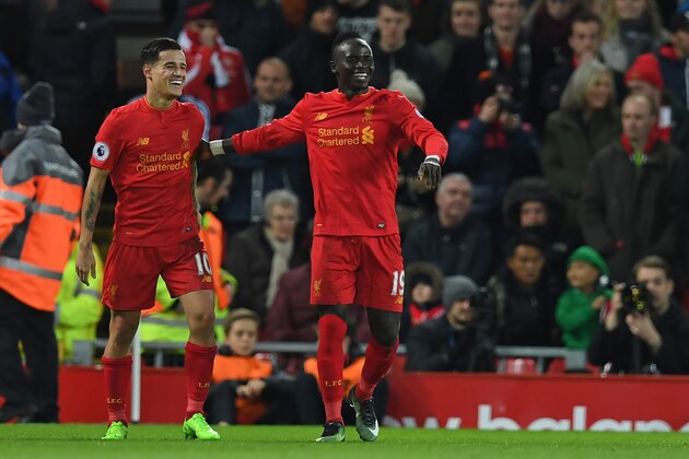 Liverpool's Senegalese midfielder Sadio Mane (R) celebrates with Liverpool's Brazilian midfielder Philippe Coutinho (L) after scoring their second goal during the English Premier League football match between Liverpool and Arsenal at Anfield in Liverpool, north west England on March 4, 2017.  / AFP PHOTO / Paul ELLIS / RESTRICTED TO EDITORIAL USE. No use with unauthorized audio, video, data, fixture lists, club/league logos or 'live' services. Online in-match use limited to 75 images, no video emulation. No use in betting, games or single club/league/player publications.  /         (Photo credit should read PAUL ELLIS/AFP/Getty Images)