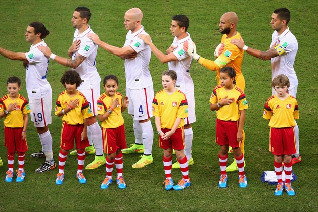 MANAUS, BRAZIL - JUNE 22:  (L-R) Graham Zusi, Geoff Cameron, Michael Bradley, Alejandro Bedoya, Tim Howard and Clint Dempsey of the United States sing the National Anthem prior to the 2014 FIFA World Cup Brazil Group G match between the United States and Portugal at Arena Amazonia on June 22, 2014 in Manaus, Brazil.  (Photo by Elsa/Getty Images)
