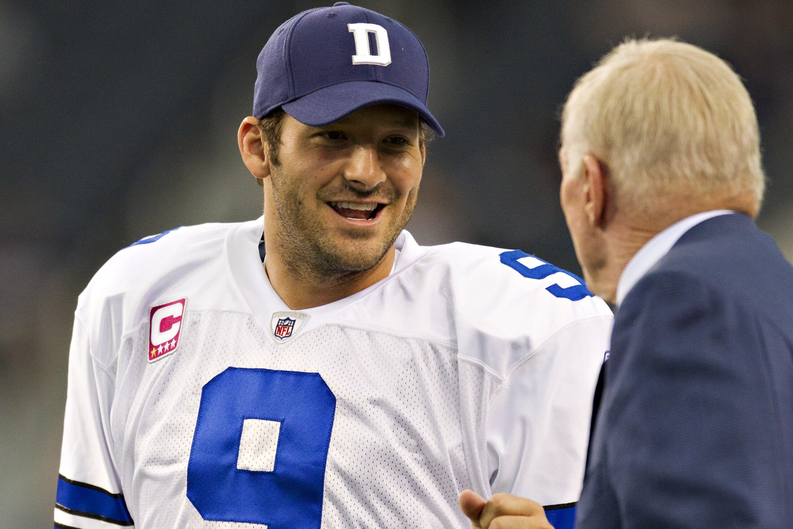 ARLINGTON, TX - OCTOBER 23:   Quarterback Tony Romo #9 bumps fist with Owner Jerry Jones of the Dallas Cowboys before a game against the St. Louis Rams at the Cowboy Stadium on October 23, 2011 in Arlington, Texas.  The Cowboys defeated the Rams 34 to 7.  (Photo by Wesley Hitt/Getty Images)