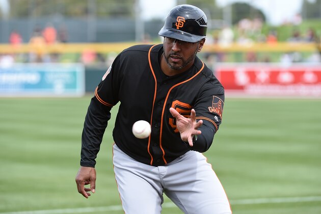 MESA, AZ - MARCH 03:  First base coach Jose Alguacil #17 of the San Francisco Giants makes a play on a bouncing foul ball during the first inning of a spring training game against the Oakland Athletics at HoHoKam Stadium on March 3, 2017 in Mesa, Arizona.  (Photo by Norm Hall/Getty Images)