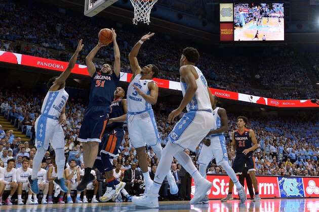 CHAPEL HILL, NC - FEBRUARY 18:  Darius Thompson #51 of the Virginia Cavaliers drives between Joel Berry II #2 and Kennedy Meeks #3 of the North Carolina Tar Heels during the game at the Dean Smith Center on February 18, 2017 in Chapel Hill, North Carolina.  (Photo by Grant Halverson/Getty Images)