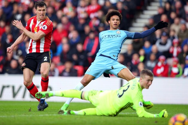 SUNDERLAND, ENGLAND - MARCH 05:  Leroy Sane of Manchester City (R) scores his sides second goal past Jordan Pickford of Sunderland (C) while Billy Jones of Sunderland (L) attempts to stop hin during the Premier League match between Sunderland and Manchester City at Stadium of Light on March 5, 2017 in Sunderland, England.  (Photo by Alex Livesey/Getty Images)