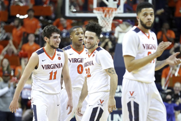 Virginia guards Ty Jerome (11), Devon Hall (0), London Perrantes (32) and Darius Thompson (51) cheer during the second half of an NCAA college basketball game against Pittsburgh, Saturday, March 4, 2017, in Charlottesville, Va. Virginia defeated Pittsburgh 67-42. (AP Photo/Ryan M. Kelly)