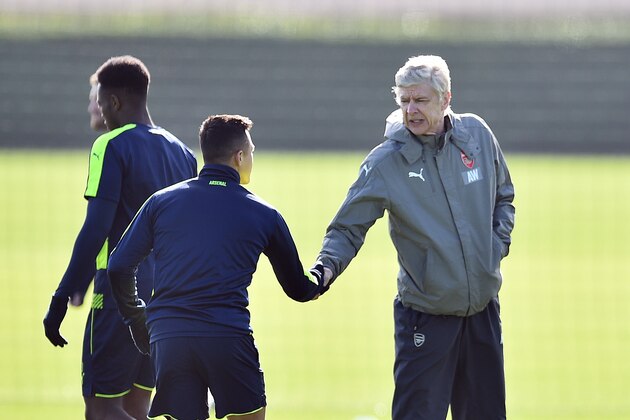 Arsenal's French manager Arsene Wenger (R) shakes hands with Chilean striker Alexis Sanchez (L) during a training session ahead of their UEFA Champions League round of 16 second leg football match against Bayern Munich at Arsenal's London Colney training ground on March 6, 2017.  / AFP PHOTO / GLYN KIRK        (Photo credit should read GLYN KIRK/AFP/Getty Images)