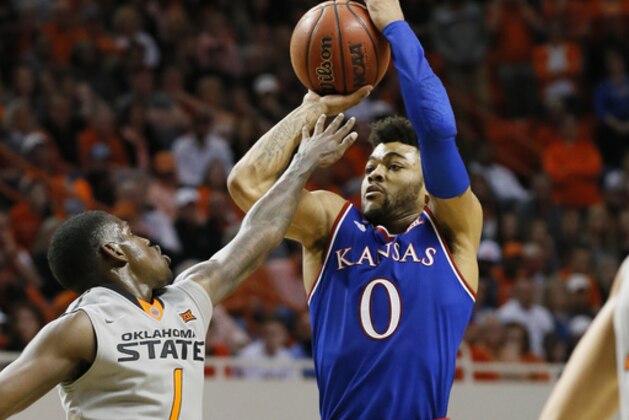 Kansas guard Frank Mason III (0) shoots over Oklahoma State guard Jawun Evans (1) in the second half of an NCAA college basketball game in Stillwater, Okla., Saturday, March 4, 2017. Kansas won 90-85. (AP Photo/Sue Ogrocki)