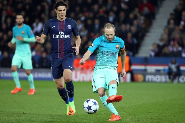 PARIS, FRANCE - FEBRUARY 14: Andres Iniesta of FC Barcelona and Edinson Cavani of PSG (left) in action during UEFA Champions League Round of 16 first leg match between Paris Saint-Germain and FC Barcelona at Parc des Princes on February 14, 2017 in Paris, France. (Photo by Jean Catuffe/Getty Images)