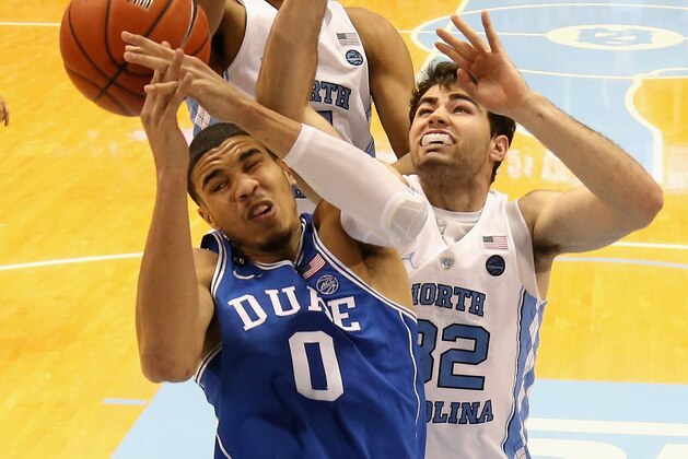CHAPEL HILL, NC - MARCH 04:  Teammates Tony Bradley #5 and Luke Maye #32 of the North Carolina Tar Heels try to stop Jayson Tatum #0 of the Duke Blue Devils during their game at the Dean Smith Center on March 4, 2017 in Chapel Hill, North Carolina.  (Photo by Streeter Lecka/Getty Images)