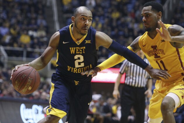 West Virginia guard Jevon Carter (2) drives to the basket while being defended by Iowa State guard Monte Morris (11) during the second half of an NCAA college basketball game, Friday, March 3, 2017, in Morgantown, W.Va. West Virginia defeated Iowa State 87-76. (AP Photo/Raymond Thompson)