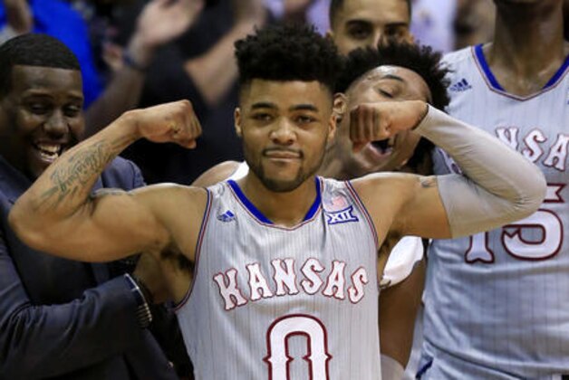 Kansas guard Frank Mason III (0) celebrates with teammates on the bench during the second half of the team's NCAA college basketball game against TCU in Lawrence, Kan., Wednesday, Feb. 22, 2017. Mason scored 20 points as Kansas defeated TCU 87-68. The Jayhawks clinched at least a tie for their 13th straight Big 12 title. (AP Photo/Orlin Wagner)