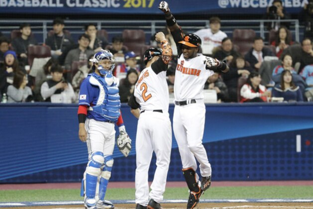 Netherlands's Jurickson Profar, right, celebrates with Andrelton Simmons after hitting a two-run home against South Korea's starting pitcher Woo Kyu-min during the first inning of their first round game of the World Baseball Classic at Gocheok Sky Dome in Seoul, South Korea, Tuesday, March 7, 2017. (AP Photo/Ahn Young-joon)