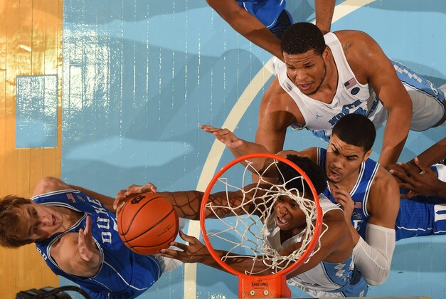 Mar 4, 2017; Chapel Hill, NC, USA; North Carolina Tar Heels forwards Isaiah Hicks (4) and Kennedy Meeks (3) and Duke Blue Devils guard Luke Kennard (5) and forward Jayson Tatum (0) fight for the rebound. The Tar Heels defeated the Blue Devils 90-83 at Dean E. Smith Center. Mandatory Credit: Bob Donnan-USA TODAY Sports