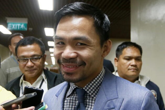Filipino boxer and Sen. Manny Pacquiao talks to reporters as he arrives for a session of the Philippine Senate Monday, Feb. 13, 2017 in suburban Pasay city, south of Manila, Philippines, amid reports that his next WBO welterweight boxing title match will be held in Abu Dhabi or Dubai in April. (AP Photo/Bullit Marquez)