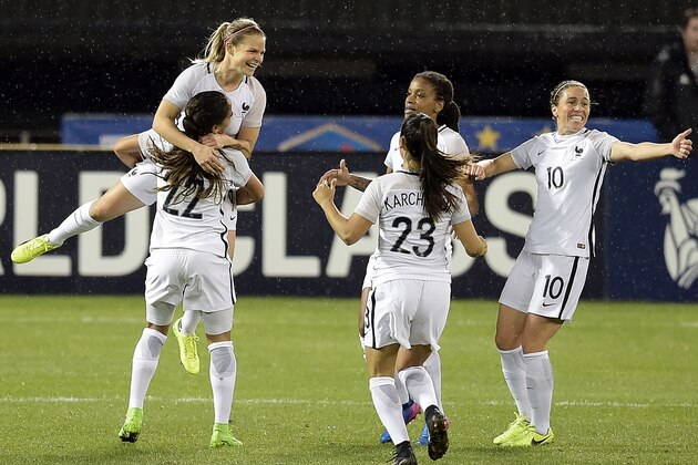 French forward Eugenie Le Sommer jumps into her teammate's arms after scoring the second goal during the She Believes Cup USA vs. France match at RFK Stadium March 7, 2017 in Washington, DC. / AFP PHOTO / Brendan Smialowski        (Photo credit should read BRENDAN SMIALOWSKI/AFP/Getty Images)