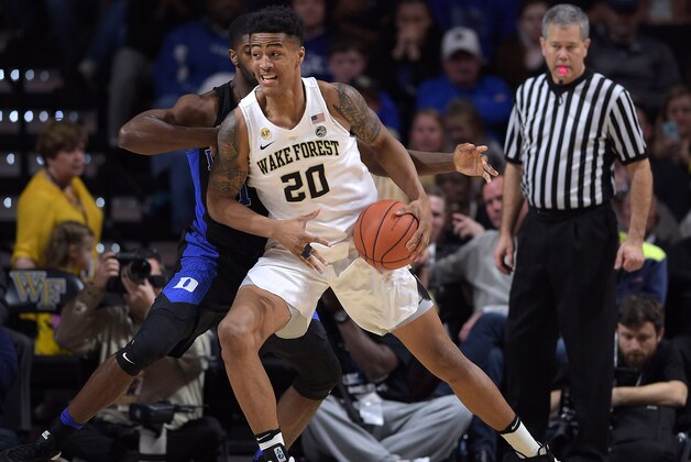 WINSTON-SALEM, NC - JANUARY 28: John Collins #20 of the Wake Forest Demon Deacons moves the ball against Amile Jefferson #21 of the Duke Blue Devils at LJVM Coliseum Complex on January 28, 2017 in Winston-Salem, North Carolina. Duke won 85-83. (Photo by Lance King/Getty Images)