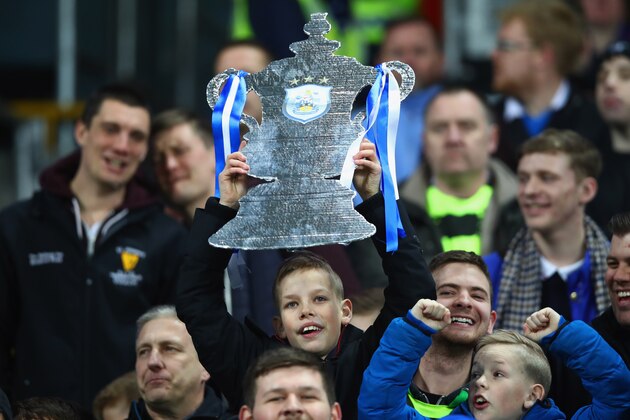 MANCHESTER, ENGLAND - MARCH 01:  A young Huddersfield fan holds a 'tin foil trophy' prior to The Emirates FA Cup Fifth Round Replay match between Manchester City and Huddersfield Town at Etihad Stadium on March 1, 2017 in Manchester, England.  (Photo by Clive Brunskill/Getty Images)