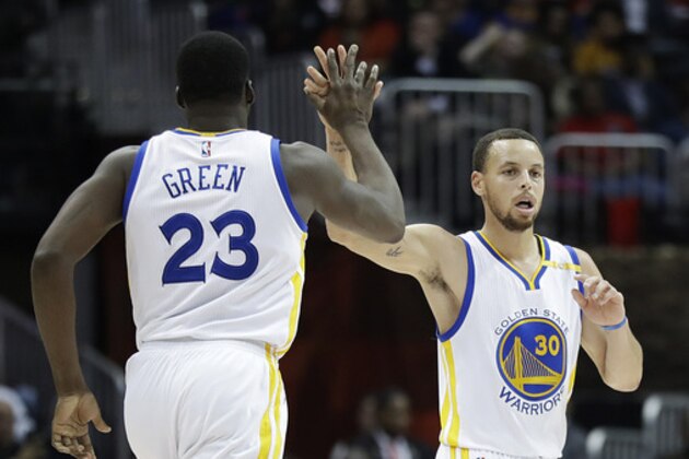 Golden State Warriors' Stephen Curry high-fives teammate Draymond Green after hitting a three-point basket in the third quarter of an NBA basketball game against the Atlanta Hawks in Atlanta, Monday, March 6, 2017. Golden State won 119-111. (AP Photo/David Goldman)