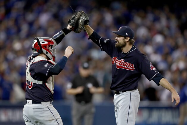 TORONTO, ON - OCTOBER 17:  Andrew Miller #24 of the Cleveland Indians celebrates with teammate Roberto Perez #55 after defeating the Toronto Blue Jays with a score of 4 to 2 in game three of the American League Championship Series at Rogers Centre on October 17, 2016 in Toronto, Canada.  (Photo by Elsa/Getty Images)