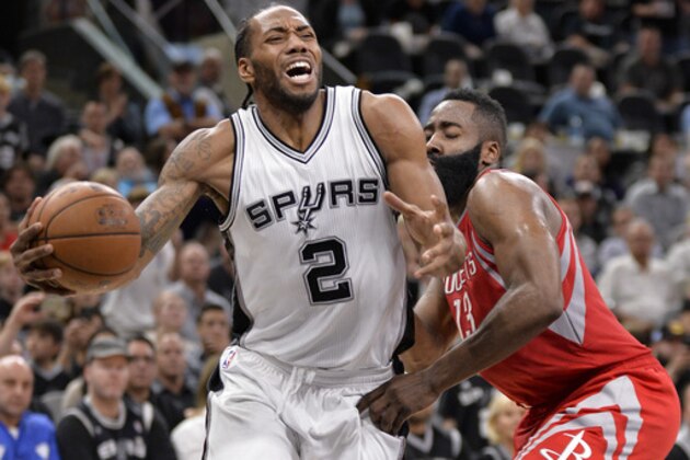 San Antonio Spurs forward Kawhi Leonard (2) is fouled by Houston Rockets guard James Harden during the second half of an NBA basketball game, Monday, March 6, 2017, in San Antonio. San Antonio won 112-110. (AP Photo/Darren Abate)