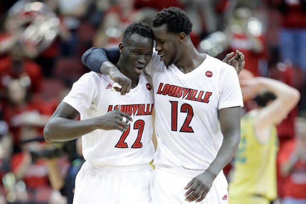 LOUISVILLE, KY - MARCH 04:  Deng Adel #22 and Mangok Mathiang #12 of the Louisville Cardinals celebrate following the 71-64 win against the  Notre Dame Fighting Irish at KFC YUM! Center on March 4, 2017 in Louisville, Kentucky.  (Photo by Andy Lyons/Getty Images)