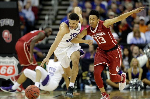KANSAS CITY, MO - MARCH 08:  Kenrich Williams #34 of the TCU Horned Frogs drives on a fast break as Jordan Shepherd #13 of the Oklahoma Sooners chases during the first round of the Big 12 Basketball Tournament at the Sprint Center on March 8, 2017 in Kansas City, Missouri.  (Photo by Jamie Squire/Getty Images)