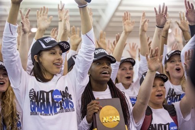 Arkansas' Sparkle McKnight, center, holds the trophy as her team