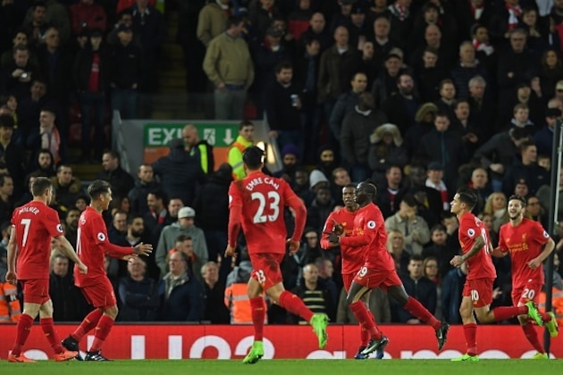 Liverpool's Senegalese midfielder Sadio Mane (3rd R) celebrates with teammates after scoring their second goal during the English Premier League football match between Liverpool and Arsenal at Anfield in Liverpool, north west England on March 4, 2017.  / AFP PHOTO / Paul ELLIS / RESTRICTED TO EDITORIAL USE. No use with unauthorized audio, video, data, fixture lists, club/league logos or 'live' services. Online in-match use limited to 75 images, no video emulation. No use in betting, games or single club/league/player publications.  /         (Photo credit should read PAUL ELLIS/AFP/Getty Images)