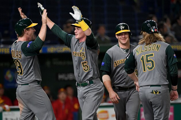 James Beresford of Australia (2nd L) is congratulated after his grand slam by teammate David Kandilas (L) in the 8th inning during the World Baseball Classic Pool B first round match between Australia and China at Tokyo Dome in Tokyo on March 9, 2017. / AFP PHOTO / TOSHIFUMI KITAMURA        (Photo credit should read TOSHIFUMI KITAMURA/AFP/Getty Images)