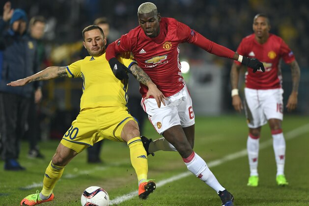 Manchester United's French midfielder Paul Pogba (R) fights for the ball with Rostov's defender Fedor Kudryashov (L) during the UEFA Europa League round of 16 football match between Rostov and Manchester United at Olimp-2 Arena in Rostov-on-Don on March 9, 2017. / AFP PHOTO / Alexander NEMENOV        (Photo credit should read ALEXANDER NEMENOV/AFP/Getty Images)