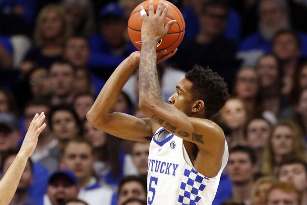 Kentucky's Malik Monk, right, shoots over the defense Florida's Canyon Barry during the second half of an NCAA college basketball game, Saturday, Feb. 25, 2017, in Lexington, Ky. (AP Photo/James Crisp)