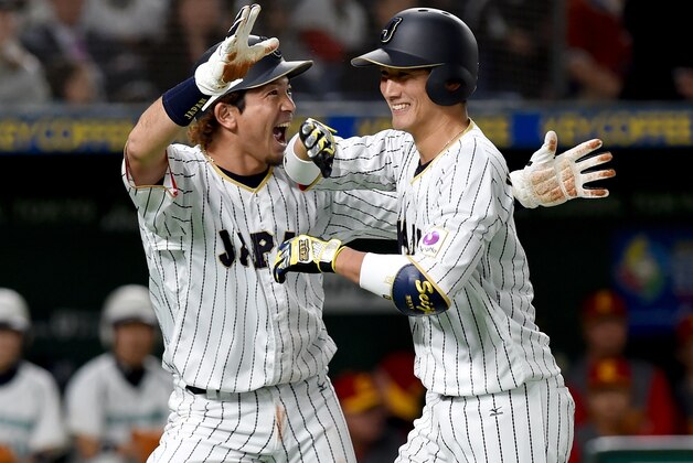 Japan's catcher Seiji Kobayashi (R) is celebrated by his teammate Nobuhiro Matsuda (L) after hitting a two-run homer in the bottom of the second inning during the World Baseball Classic Pool B first round match between Japan and China at Tokyo Dome in Tokyo on March 10, 2017. / AFP PHOTO / TORU YAMANAKA        (Photo credit should read TORU YAMANAKA/AFP/Getty Images)