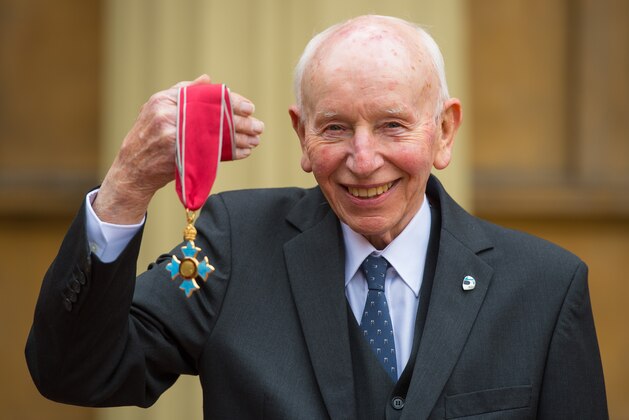 LONDON, ENGLAND - MARCH 15:  Motor racing legend John Surtees with his Commander of the Order of the British Empire (CBE) medal which was awarded by the Duke of Cambridge at an investiture ceremony at Buckingham Palace on March 15, 2015 in London, England. (Photo by Dominic Lipinski - WPA Pool/Getty Images)