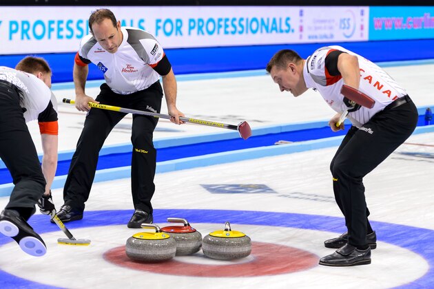 (From L) World Champion Canada's team: third Marc Kennedy, second Brent Laing and lead Ben Hebert react during the winning point at the gold medal game against Denmark at the World Men's Curling Championships on April 10, 2016 in Basel. / AFP / FABRICE COFFRINI        (Photo credit should read FABRICE COFFRINI/AFP/Getty Images)